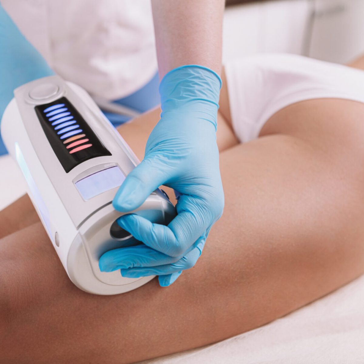 Cropped shot of a woman getting body sculpting treatment at beauty clinic. Cosmetologist using endospheres therapy machine on a female client